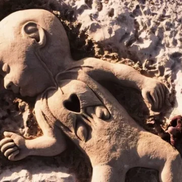 cuoricino domenico Scultura in sabbia sul litorale sardo per il piccolo Domenico. Cuoricino stilizzato in evidenza sul petto